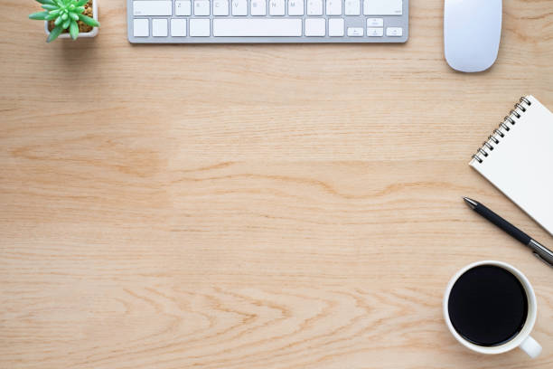 istock Wood office desk table with keyboard, notebook and coffee cup with equipment other office supplies. Business and finance concept. Flat lay with blank copy space. 1249681510