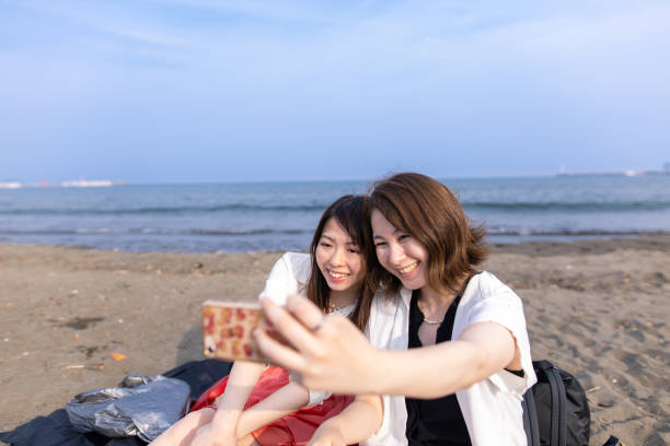 istock Young women taking selfit picture at beach 1249681554