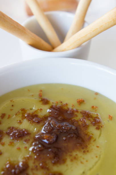 istock Green pea cream soup in bowl with sprouts, bread toasts 1249682203