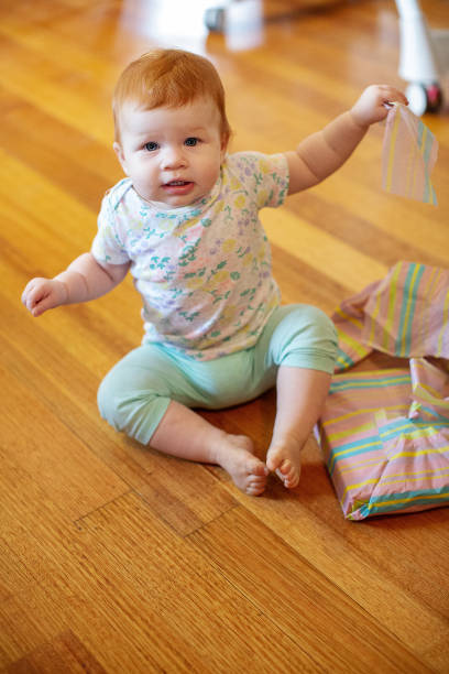 istock Girl on her first birthday with birthday presents 1249686698