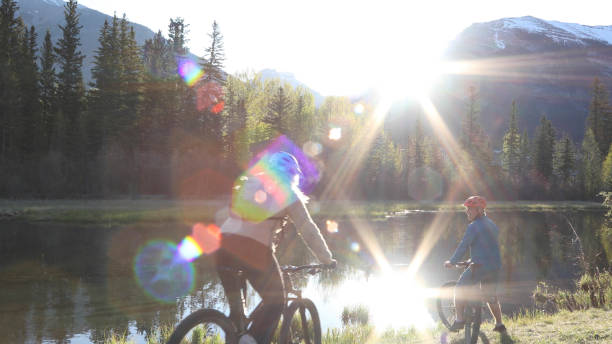 istock Couple on e-bikes ride along riverside in the morning 1249689787