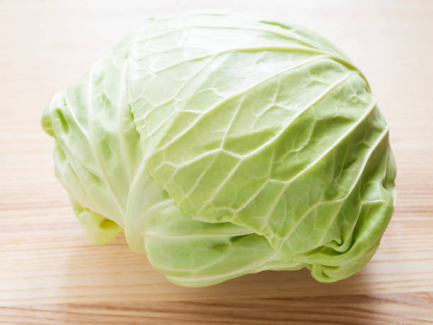 istock Fresh green cabbage on wooden background 1249689849