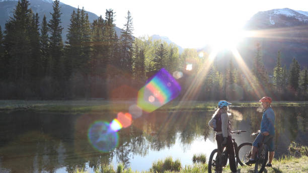istock Couple on e-bikes relax along riverside in the morning 1249689911