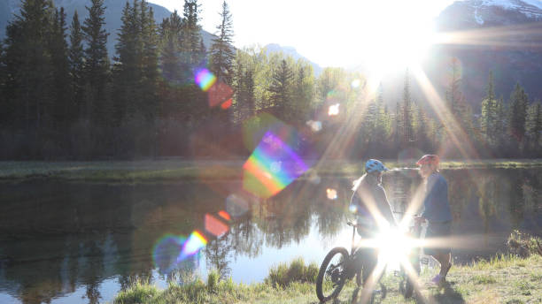 istock Couple push e-bikes along riverside in the morning 1249690007