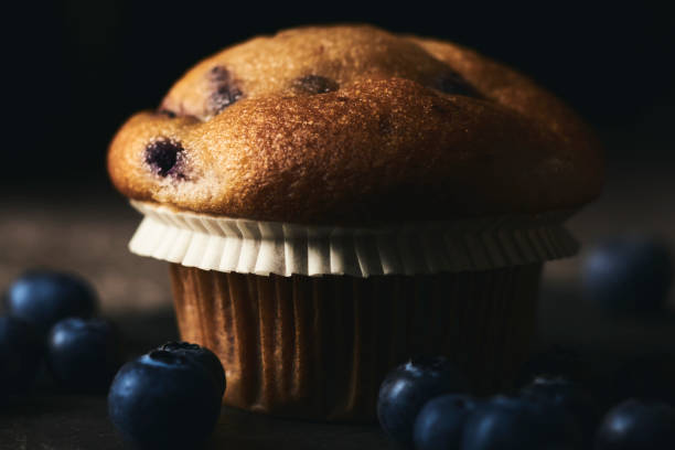 istock Blueberry Muffin with fresh blueberries. Dark mood. 1249690067