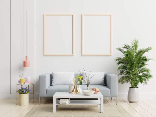 istock Poster mockup with vertical frame standing on floor in living room interior with sofa. 1249693025