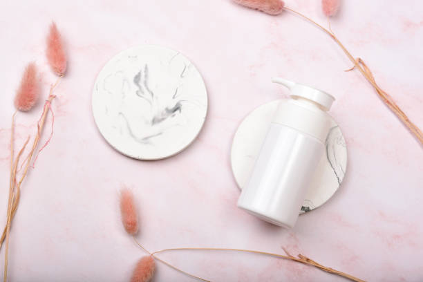 istock Cosmetic bottle containers on pink marble background, Blank label package for branding mock-up, Natural organic beauty product concept, Research and development of purified skincare. 1249693900