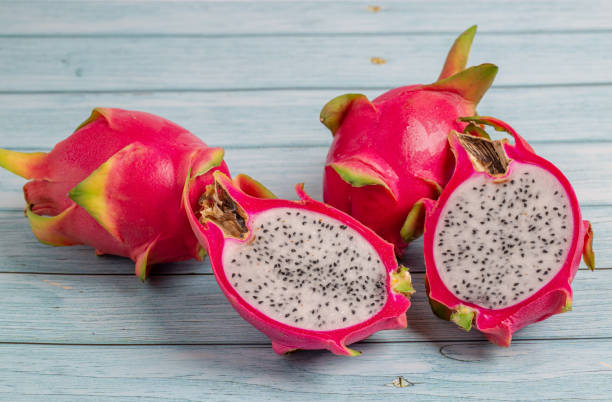 istock Dragon fruit on blue wooden background. 1249697289