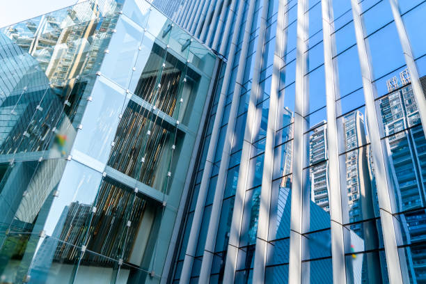 istock Looking up at the glass curtain wall of skyscraper 1249703443