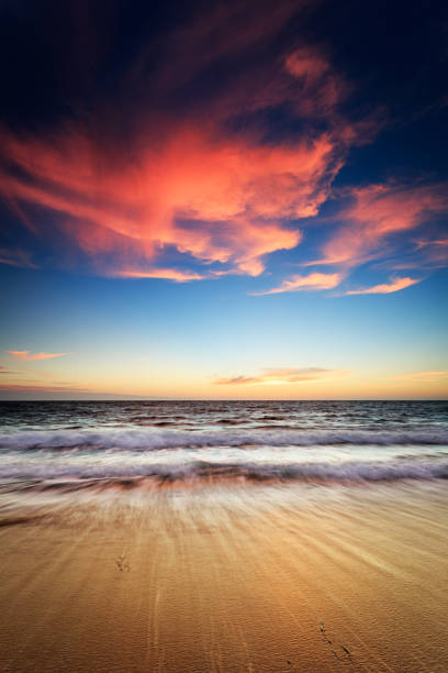 istock Sunset at the beach with dramatic colour in the cloud 1249704221