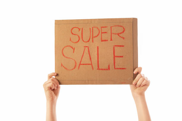 istock Hands hold a cardboard advertising board on a white background. This is a super sale. 1249704314