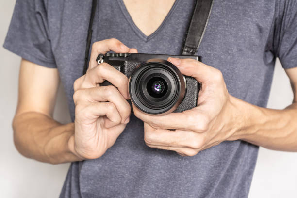 istock photographer holding a camera at chest level 1249706686