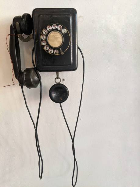 istock Old telephone hanging on the wall 1249709808