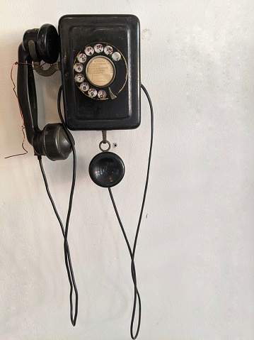 Old telephone hanging on the wall