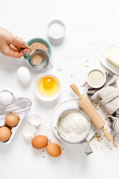 istock Baking homemade bread on white kitchen worktop with ingredients for cooking, culinary background, copy space, overhead view 1249715573