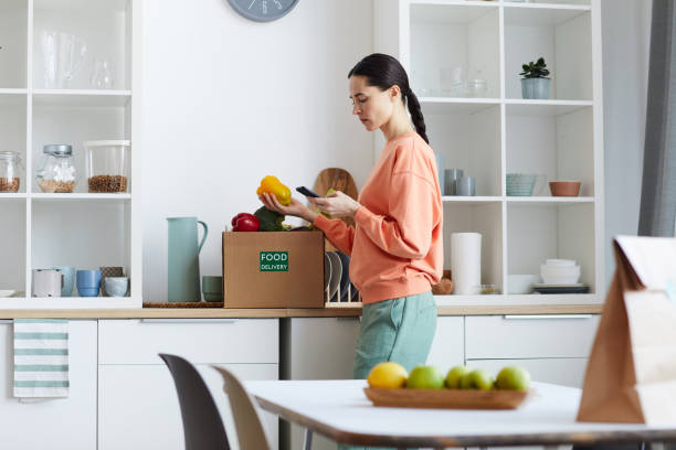 istock Woman checking food delivery 1249716817