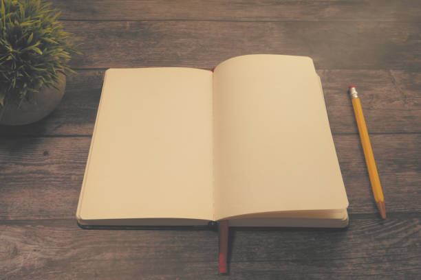 istock high angle view of open diary, tea and eyeglass on wooden table 1249718569