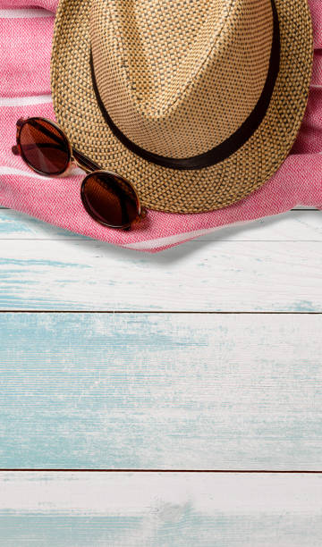 istock Hat, towel and sunglasses on wooden surface. Top view. Summer holiday concept element. Isolated on white background. 1249723332