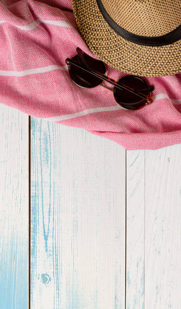 istock Hat and towel on wooden surface. Top view. Summer holiday concept element. Isolated on white background. 1249723620