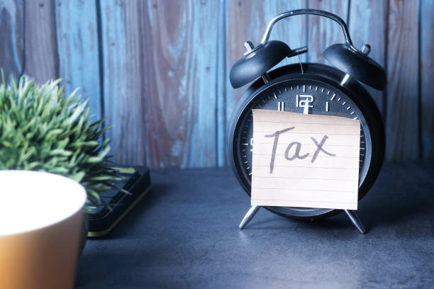 istock Tax Text on Adhesive Note on Alarm Clock 1249724211