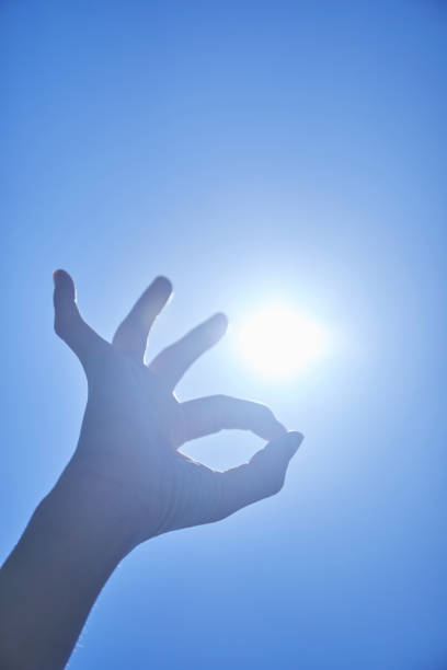 istock Young woman reaching for the blue sky 1249727678