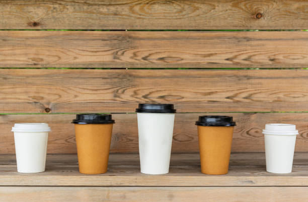 istock Paper cups for coffee on a wooden background 1249728803