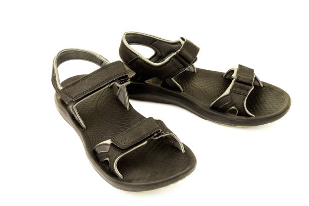 istock Pair of black leather sandals isolated on white background 1249729161