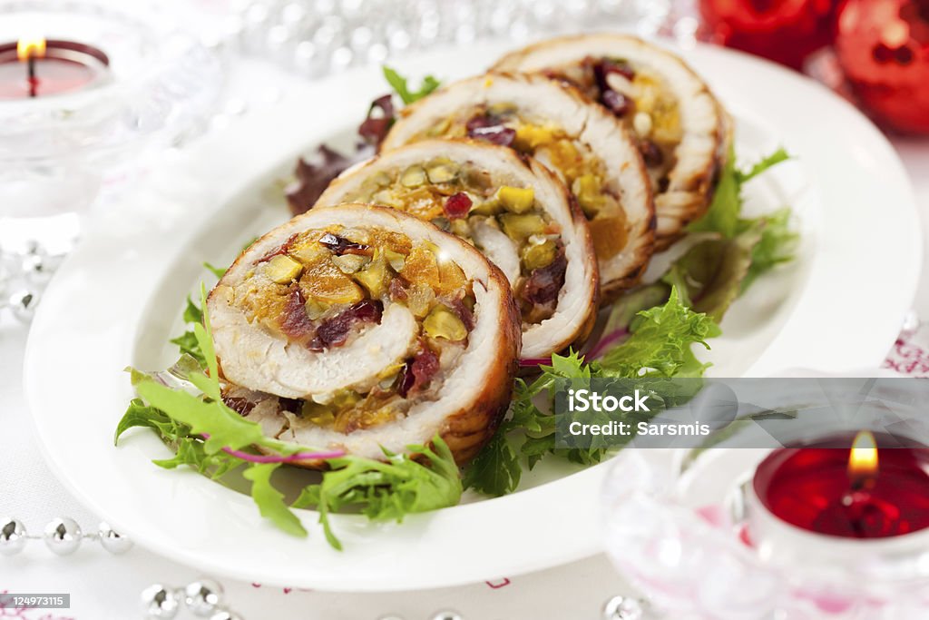Stuffed turkey breast cut into pieces Turkey breast stuffed with cranberry,apricot and pistachio for Christmas Roulade Stock Photo