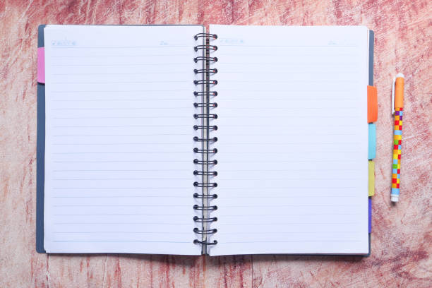 istock high angle view of open diary on wooden table 1249732217