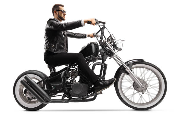 istock Profile shot of a biker on a custom chopper riding with sunglasses 1249732864