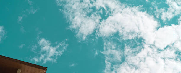istock Low angle shot of blue sky above building 1249733447