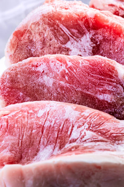 istock Raw frozen meat. raw pork chops 1249734847