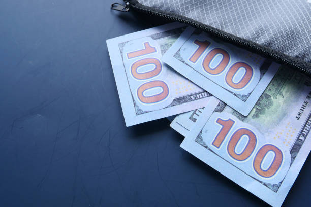 istock Close up of cash in wallet on table 1249734917