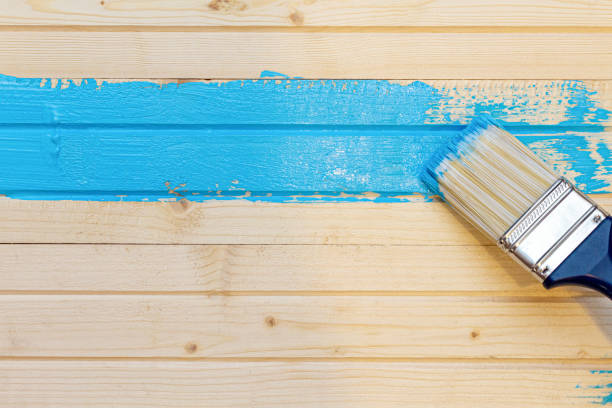 istock brush stroke with blue paint on wooden planked background 1249735097