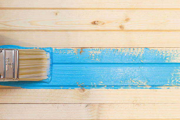 istock brush stroke with blue paint on wooden planked background 1249735164