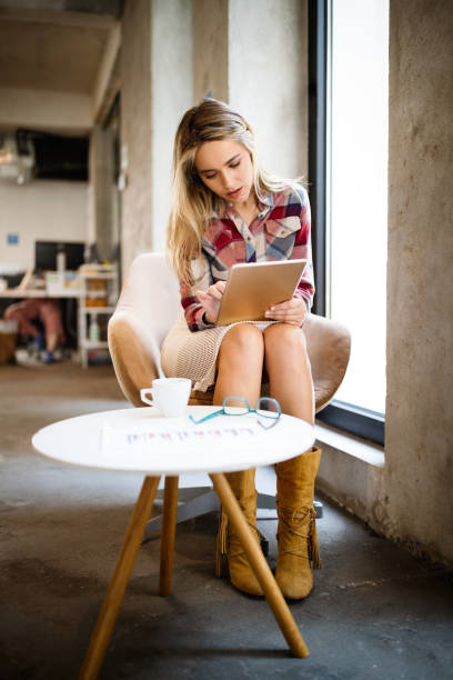 istock Beautiful business woman holding tablet computer in office 1249736190