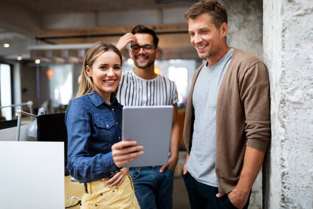 istock Business people having fun and chatting at workplace office 1249736492