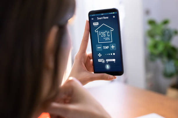 smart home system close up of asian young woman using smart home app on mobile phone to control air conditioner temperature smart thermostat photos stock pictures, royalty-free photos & images