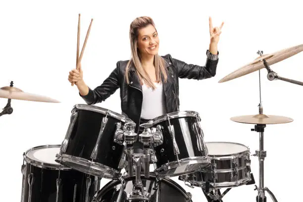 Photo of Beautiful female musician playing percussion drums