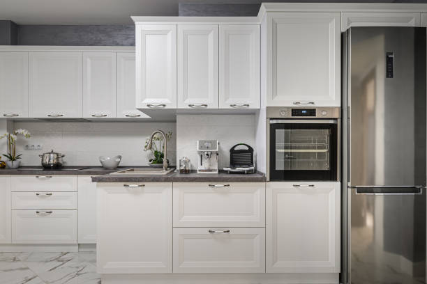 istock Electric appliances in minimalistic white kitchen interior 1249737848