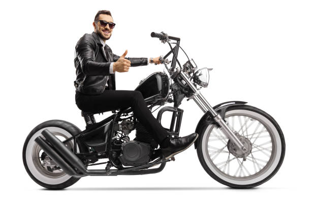 istock Biker on a custom chopper riding and showing thumbs up 1249738158