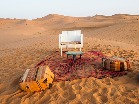 Diverse furniture with a carpet to rest in the desert of Morocco