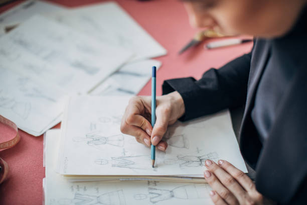 istock Lady fashion designer drawing a sketch in her workshop 1249739629