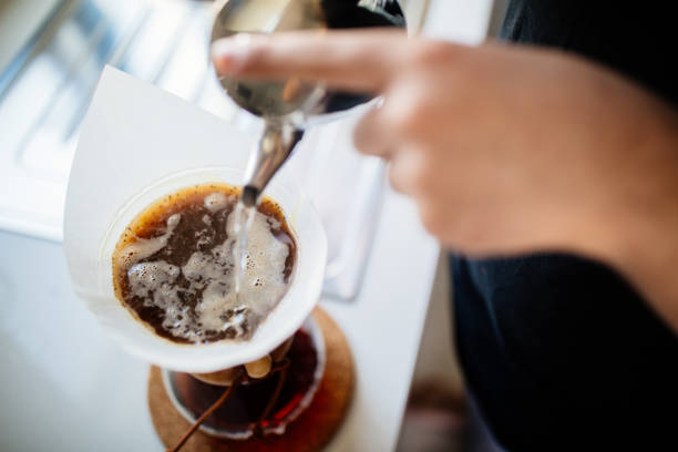 Teenage brewing coffee at home