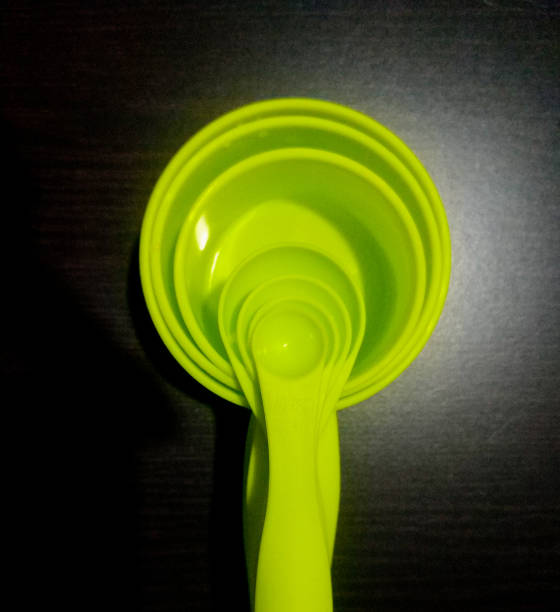 istock a set of green colour measurement cups and spoon 1249739999