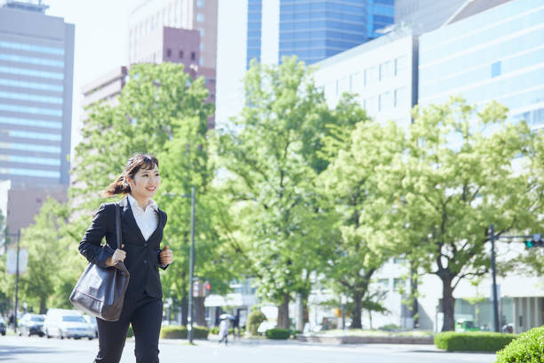 istock Young business woman running in the office district 1249740412