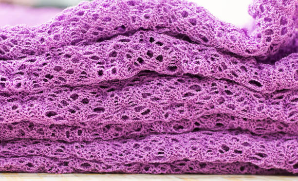 istock openwork knitted details in lilac color stacked as a background 1249742651