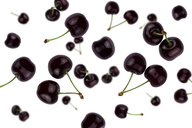istock A falling ripe cherry isolated on a white background with clipping path. Flying food. Top view. 1249745091