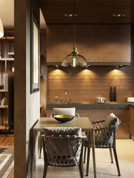 istock Dining room with contemporary style kitchen in dark brown studio apartments. Partition wall separating the living room and kitchen. 1249745173