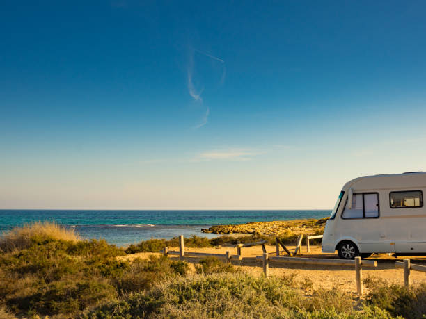 istock Camper car on beach, camping on nature 1249745873